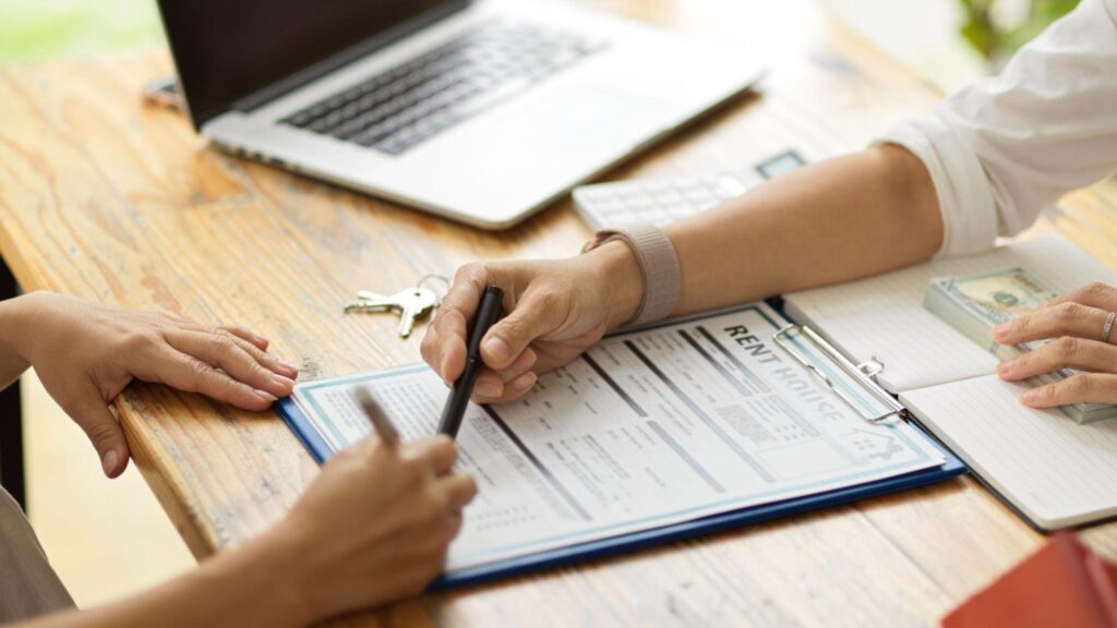 Ventura landlord reviewing rental paperwork and considering property management