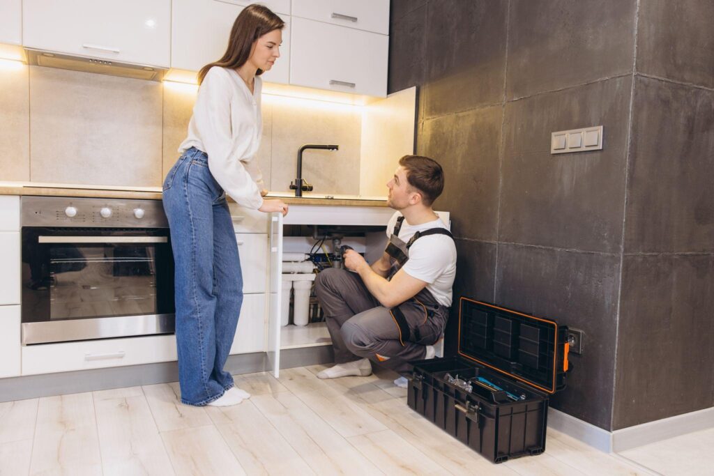 Maintenance technician repairing residential rental property issue